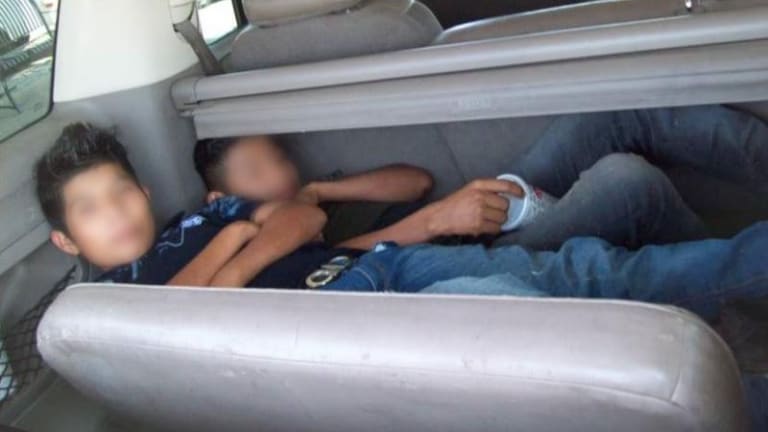 WOMAN SMUGGLED ILLEGAL IMMIGRANTS IN TRUNK OF CAR 