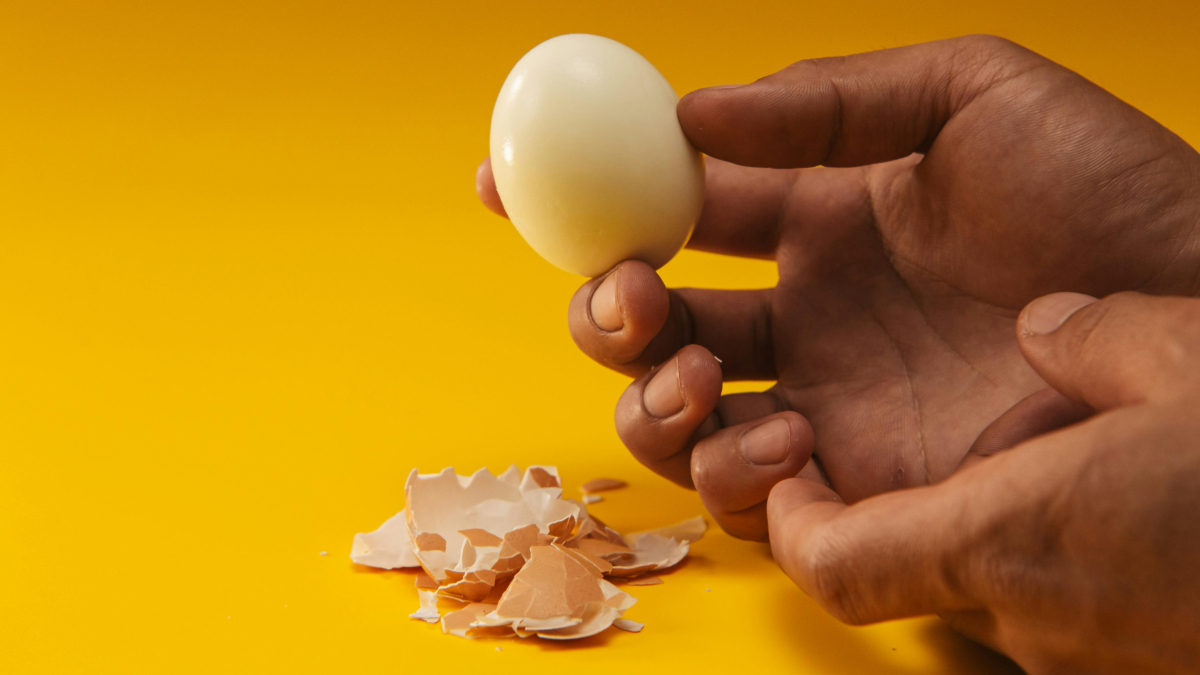 What is the best method to perfectly peel a hard-boiled egg?